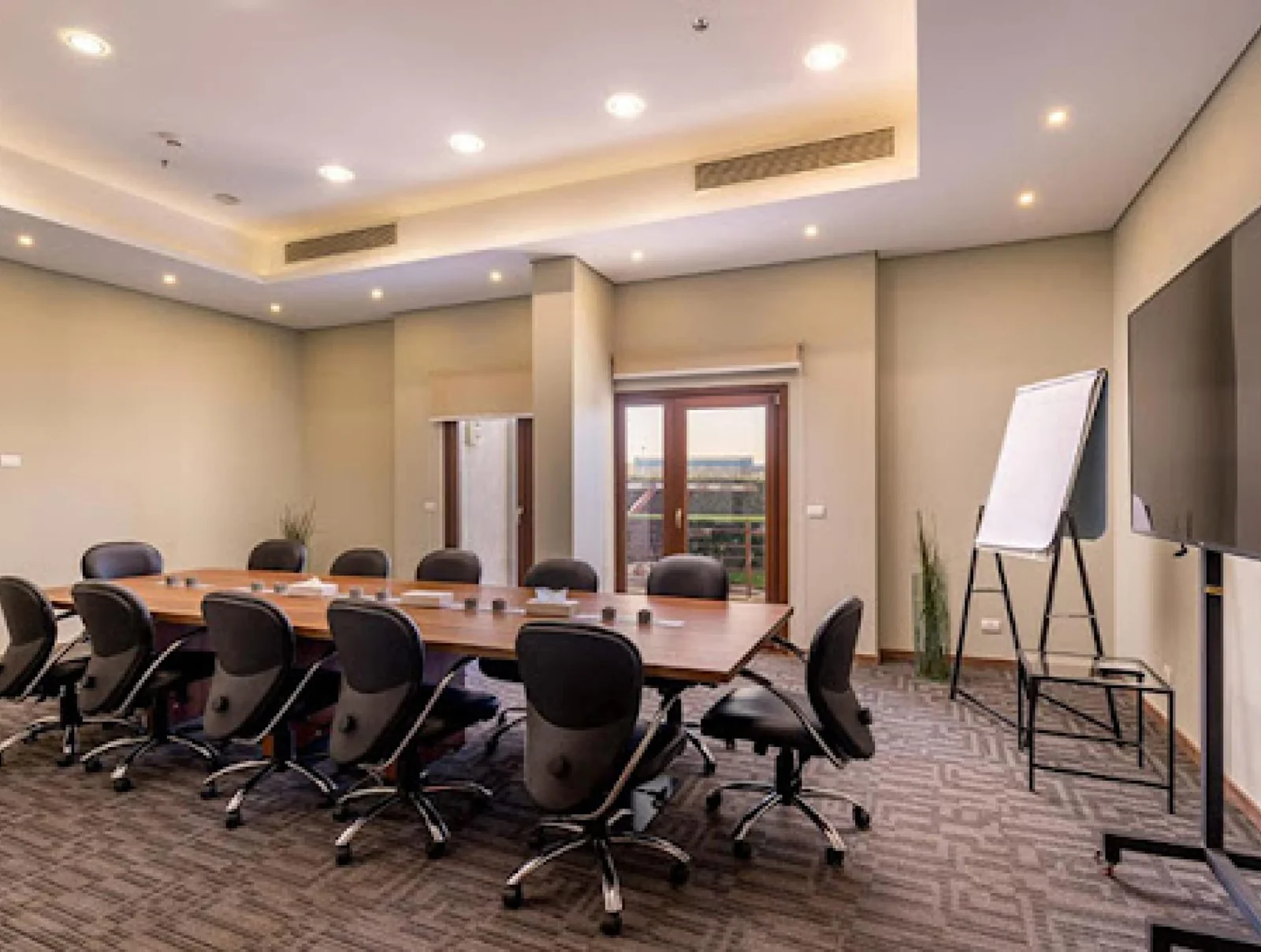 Corporate boardroom with long wooden table